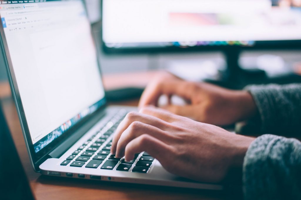 person typing on computer screen