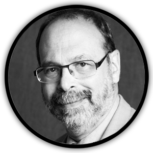 Man wearing glasses smiling.